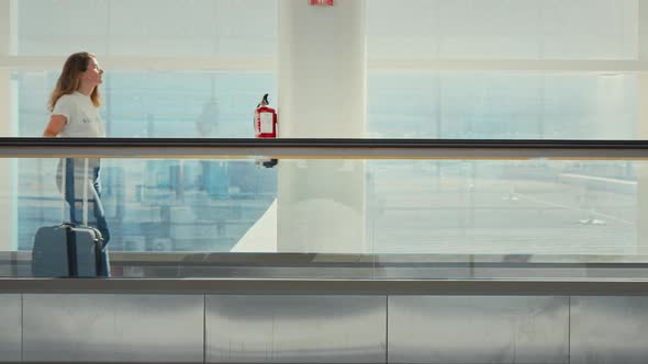 Young Millennial Traveler Woman in Empty Airport