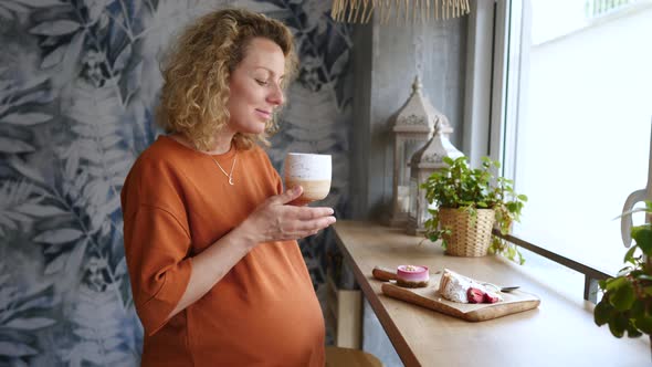 Beautiful Young Pregnant Girl Sitting In Cafe Drinking Tea With Cakes