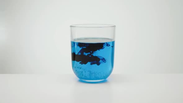 Paint Spreading In Liquid. Glass Of Water.