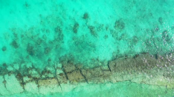 Beautiful abstract texture from turquoise lagoon surface with rocky bottom and coral reefs thriving