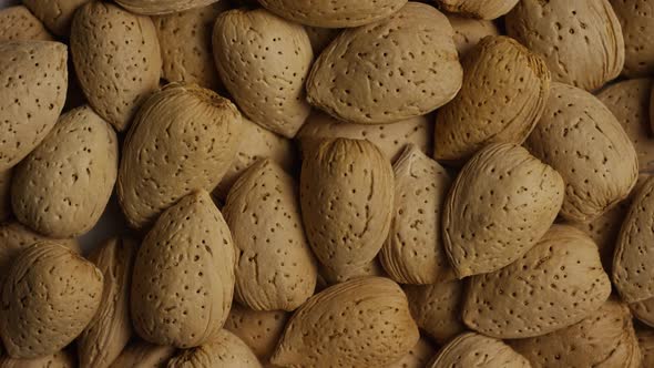 Cinematic, rotating shot of almonds on a white surface - ALMONDS