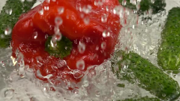 The washing of the bell peppers and cucumbers before eating