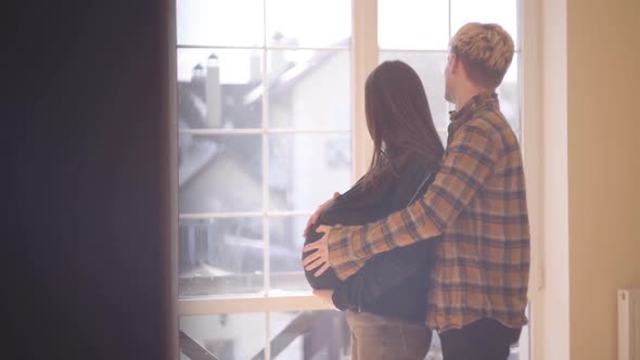 The Young Man Caressing the Belly of His Pregnant Girlfriend