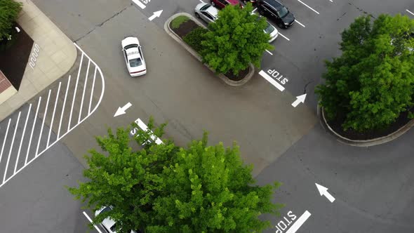 Aerial follow police car through parking lot.