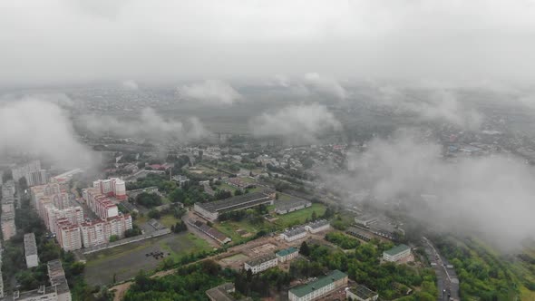 Aerial View of City Through Clouds Descending Slowly