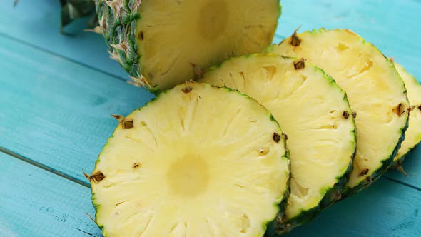 Slices of Pineapple on Blue Wood