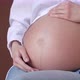 Young Pregnant Woman Stroking Her Belly Closeup - VideoHive Item for Sale