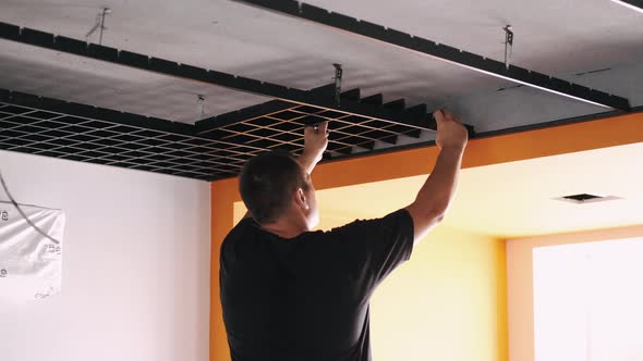 Male Workers Installing Panels for Open Cell Ceiling