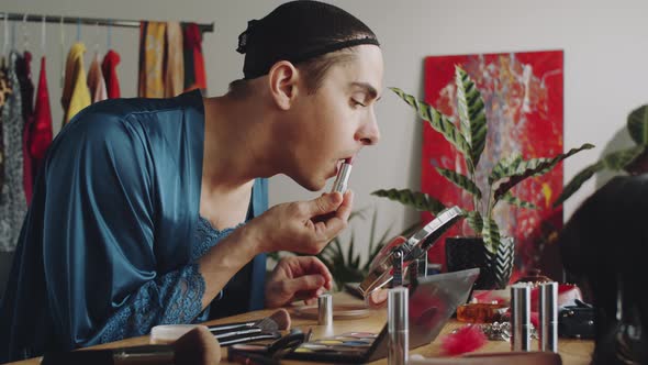 Glamorous Transgender Man Applying Lipstick at Home