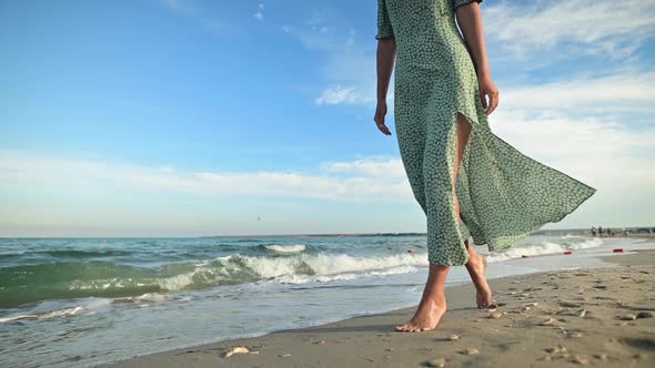 Attractive Woman in Slow Motion Walking Barefoot Along the Beach in the Early Morning