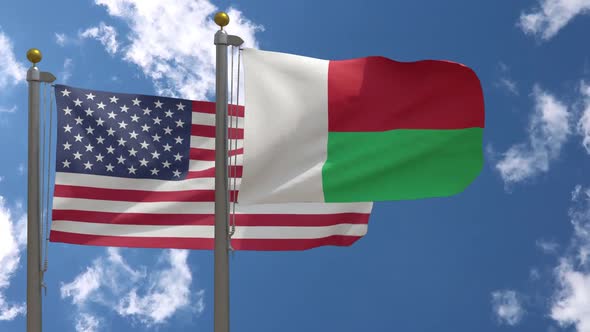Usa Flag Vs Madagascar Flag On Flagpole