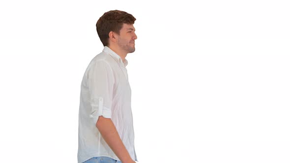 Casual Young Man Walking and Looking Forward on White Background.