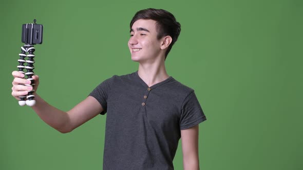 Young Handsome Iranian Teenage Boy Against Green Background