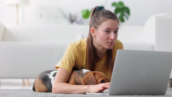 Woman with Dog on Floor Browse Internet Relax with Gadget and Cute Pet Beagle