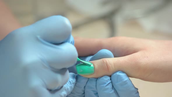 Manicurist Accurately Applying Nail Varnish