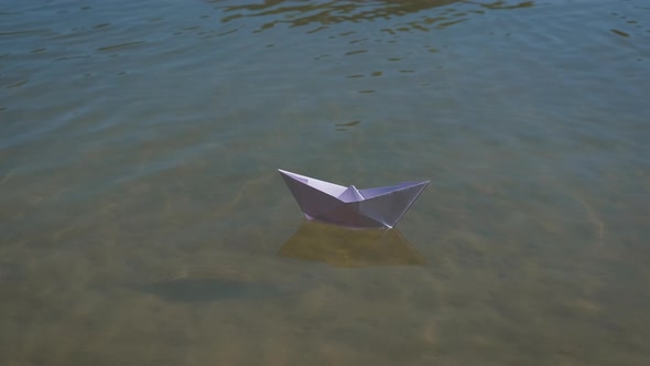 Paper boat on the water.