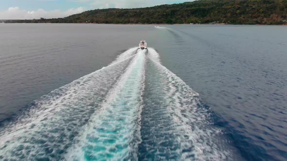 Tracking Aerial View of Speedboat Sailing in Tropical Sea Toward Coastline of Exotic Island