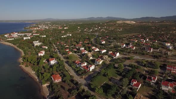 Aerial View of Green Lands and Houses on Sea Coast. Trikorfo Beach, Greece