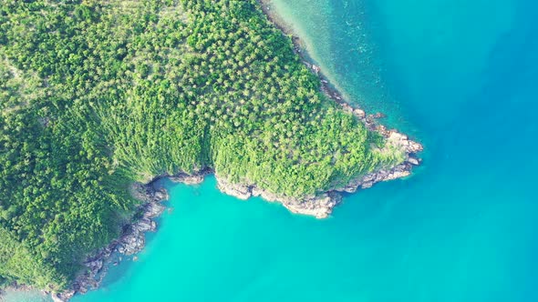 beautiful cliffs under the palm forest and rocky shore of Thailand azure sea. aerial