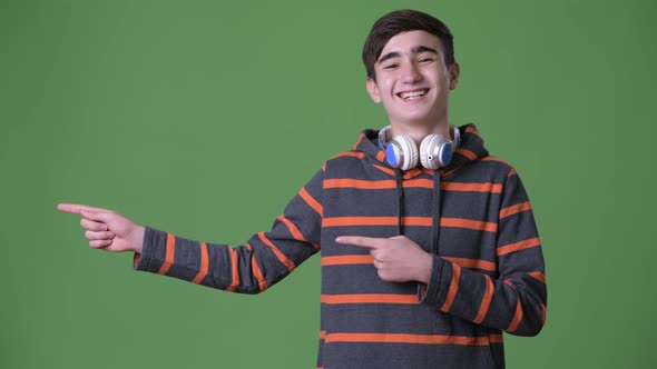 Young Handsome Iranian Teenage Boy Against Green Background