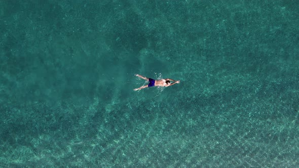 Boy Swims Breaststroke in the Ocean