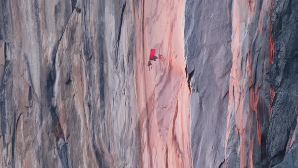 Mountain Climber Hanging on Rope on El Capitan Mountain at Red Orange Sunset 6K