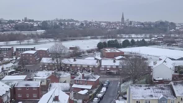 Ascending drone shot of a snowy Exeter looking towards the town centre CROP