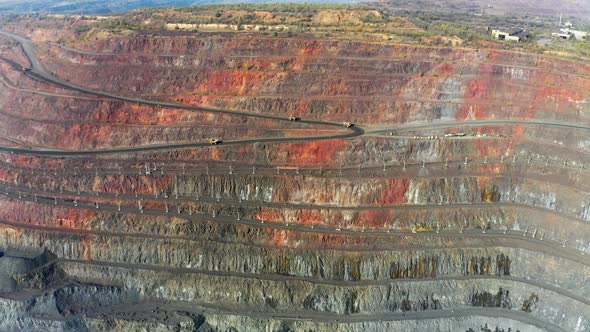 Huge Belaz Trucks Driving on the Pit Bottom in Mining Factory Mine Quarry in Ukraine