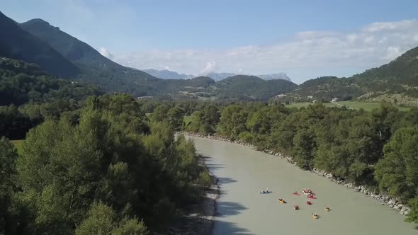 several different boatings going upon river filmed from the sky