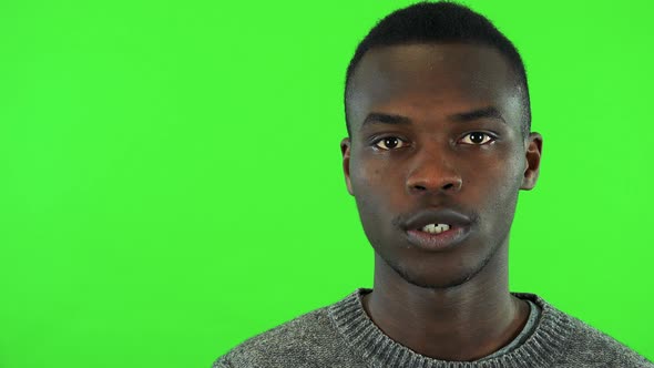 A Young Black Man Talks To the Camera - Face Closeup - Green Screen Studio