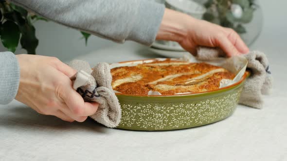 Female Hands Puts Banana Bread on Dinner Table