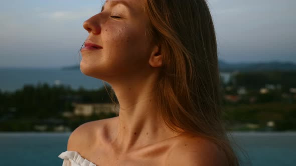 Close Up of Woman Face Looking at Sunset Relax and Deep Breathing on Rooftop