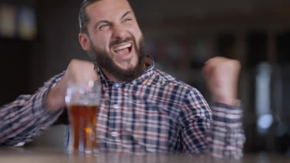 Excited Happy Sports Fan Cheering Gesturing in Pub Indoors