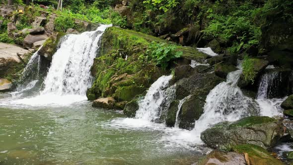 Mountain River Waterfall Flowing Between Rocky Shores in Carpathians Mountains Ukraine