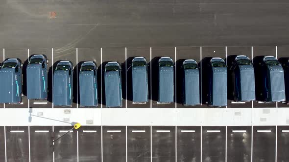 Amazon vans in the parking lot of an Amazon warehouse - aerial drone