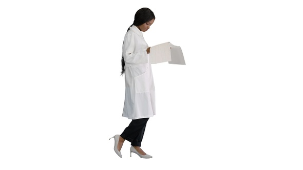 Afro American Doctor Woman Walking and Looking at Cardiogram