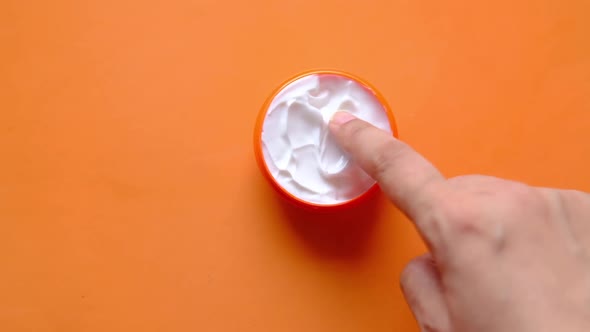 Woman Applying Beauty Cream Onto Skin on