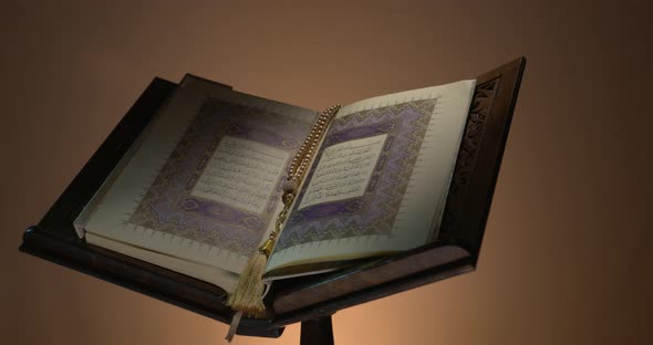 Holy Quran On Book Rest With Prayer Beads