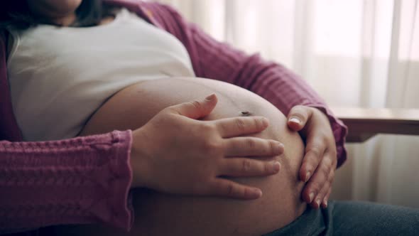 Happy Pregnant Woman and Expecting Baby at Home