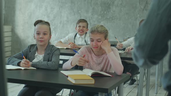 Children Writing Notes in Class During Lesson