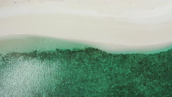 Daytime birds eye abstract view of a white paradise beach and aqua turquoise water background in 4K