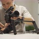 An Asian man is installing a camera rig and fastening it - VideoHive Item for Sale