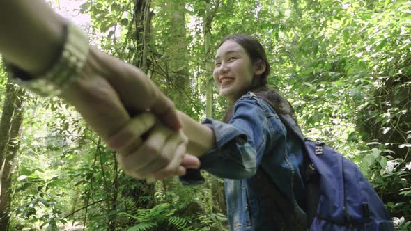 Holding Hand Of Her Boyfriend While Walking In The Forest