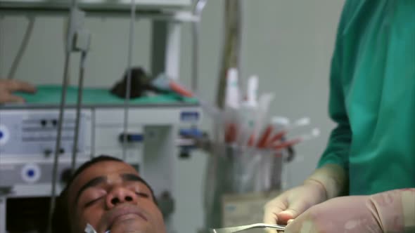 Surgeon holding a scissors during an operation