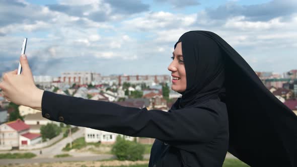 Happy Islamic Woman in Black Headscarf Taking Selfie Use Smartphone Mountain Peak Over Muslim City