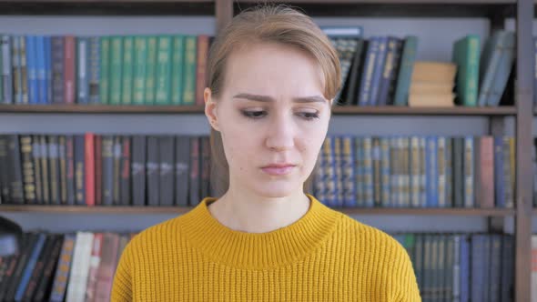 Portrait of Sad Young Woman Looking at Camera