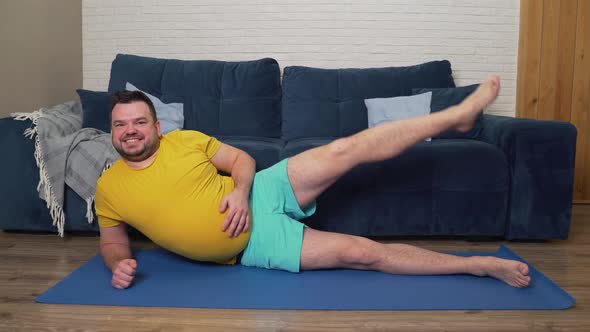 Plump Man with a Beard Does Physical Exercises to Lose Weight