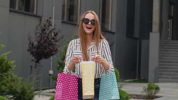 Girl Holding Colorful Shopping Bags, Rejoicing Discounts in Fashion Store, Enjoying Shopping in Mall