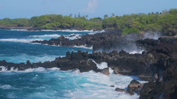 Waves crashing into shore on Hawaii