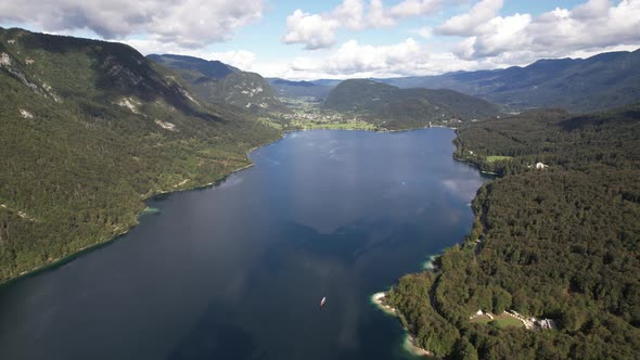 Aerial view on Bohinj lake between mountains with forest in Slovenia, Europe